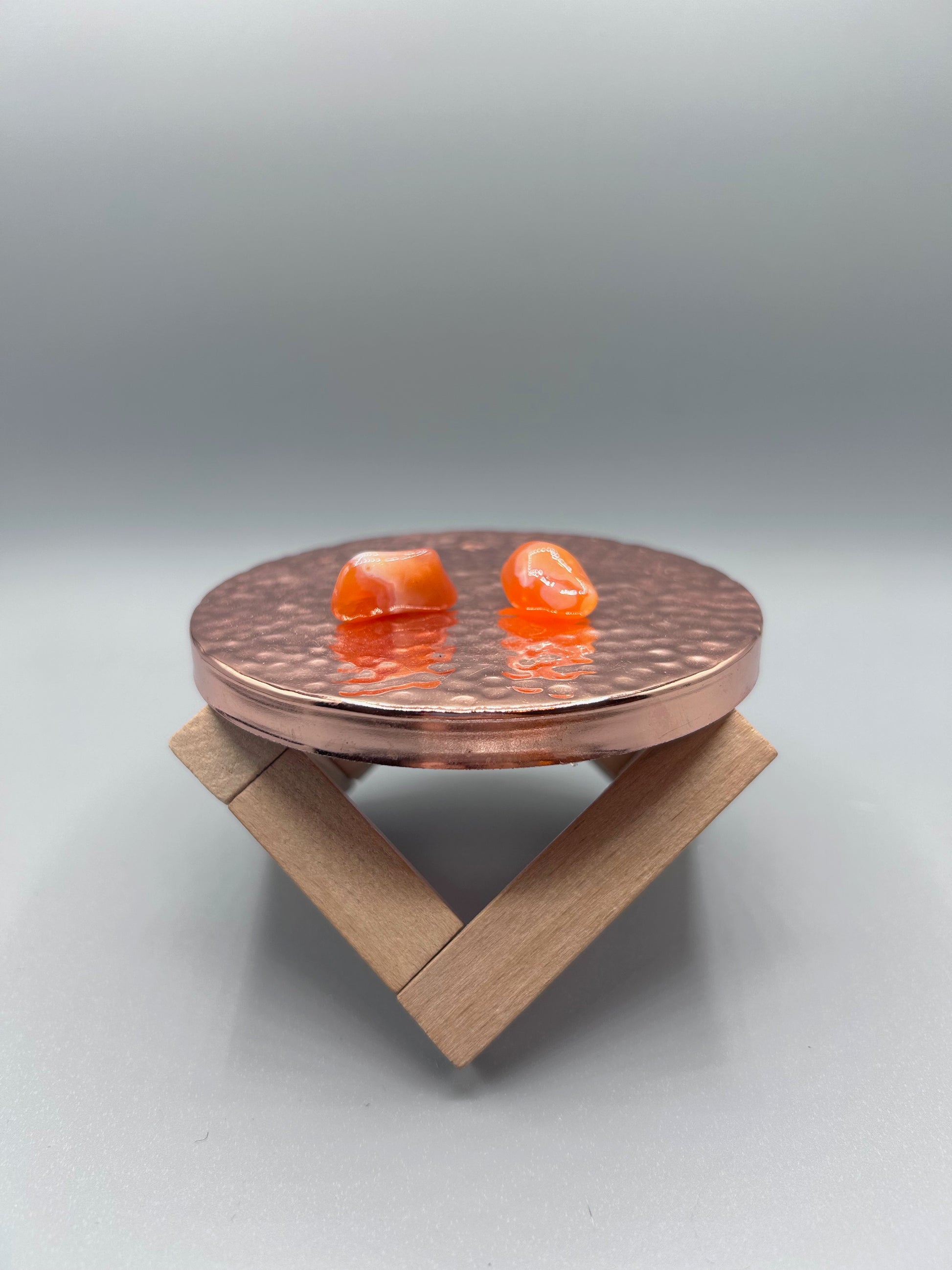 two tumbled banded carnelian stones