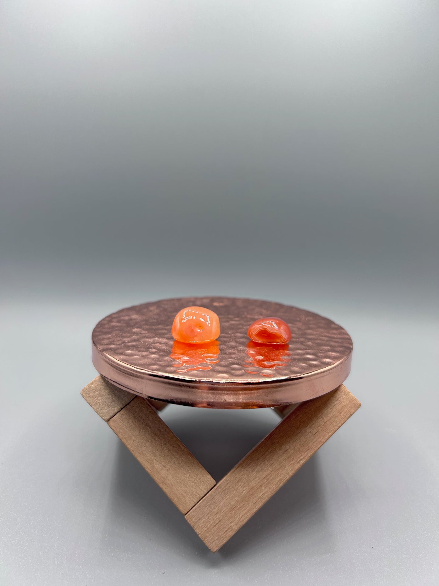 two tumbled banded carnelian stones