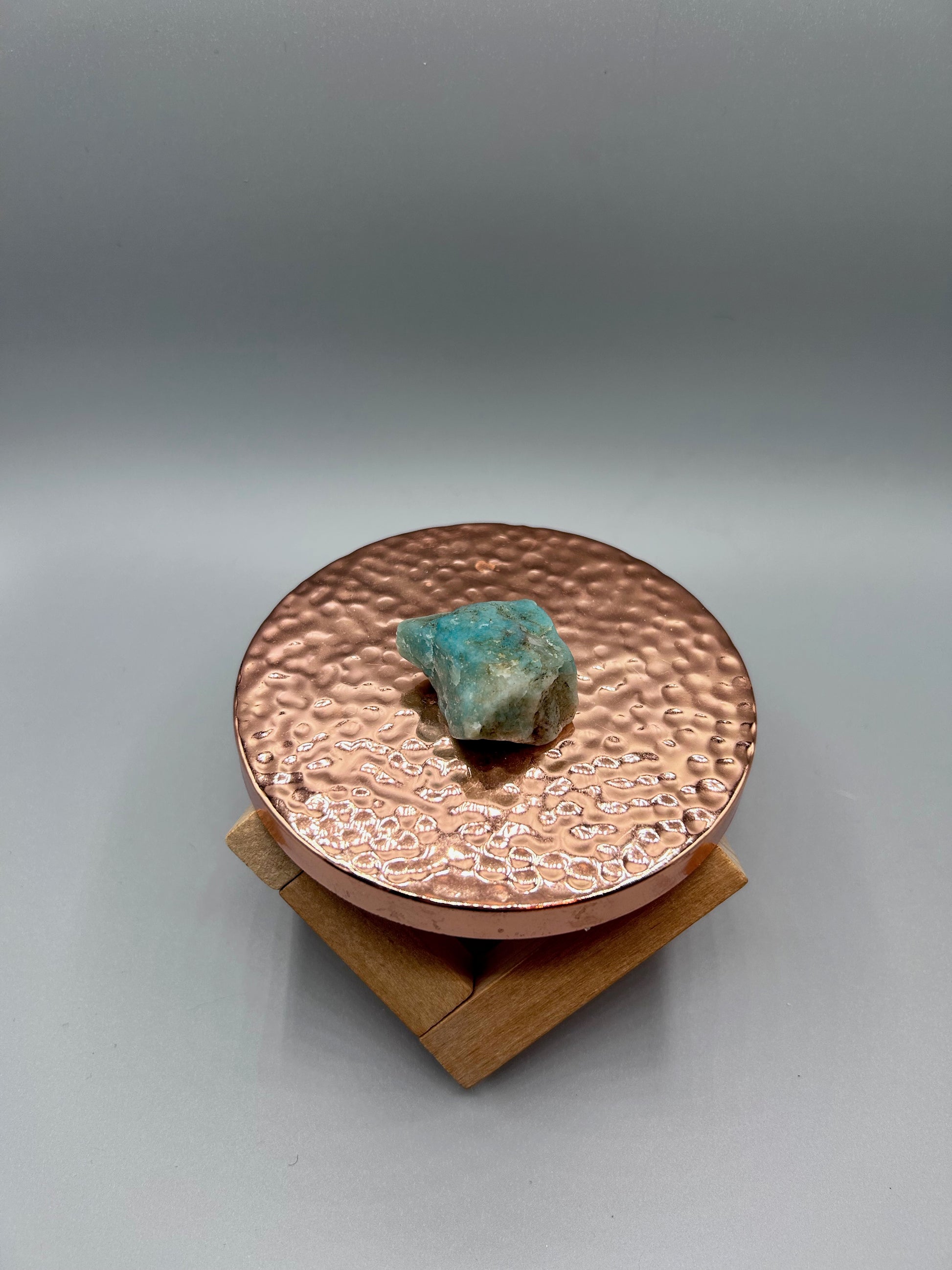amazonite stone posed inside on copper plate. 